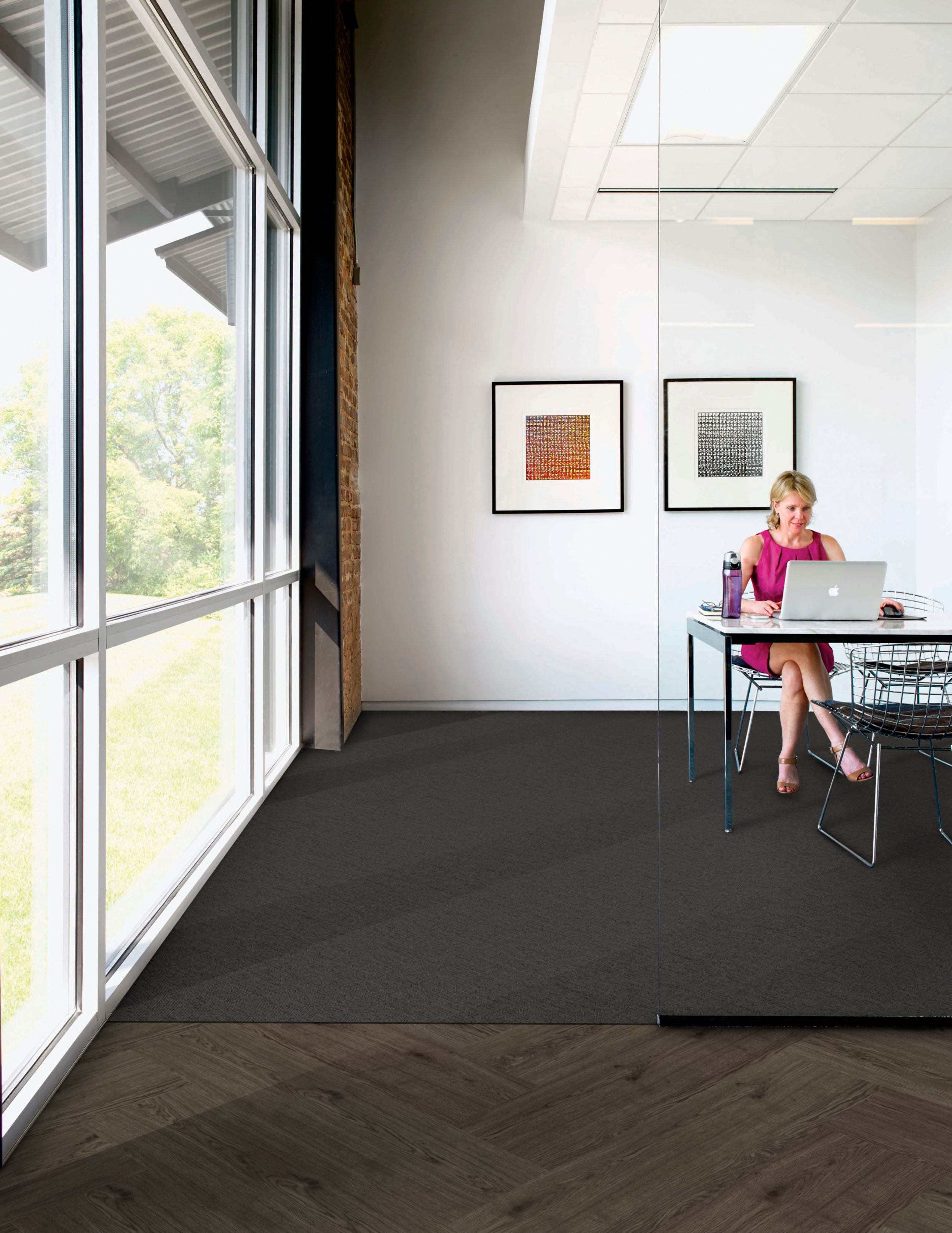 Interface UR303 carpet tile in private office with woman at computer and Natural Woodgrains LVT in outer office image number 4
